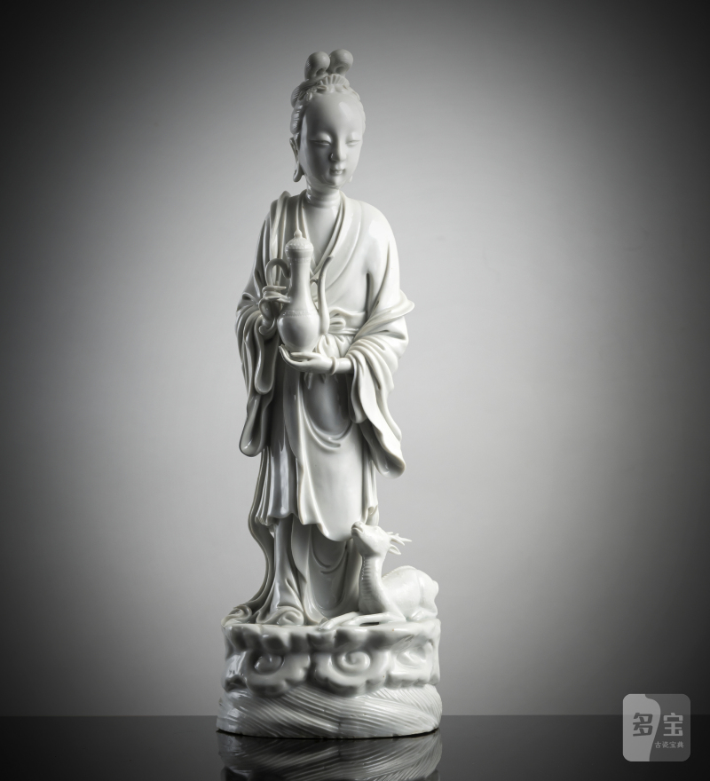 A Dehua figurine of an immortal with a deer and a jug